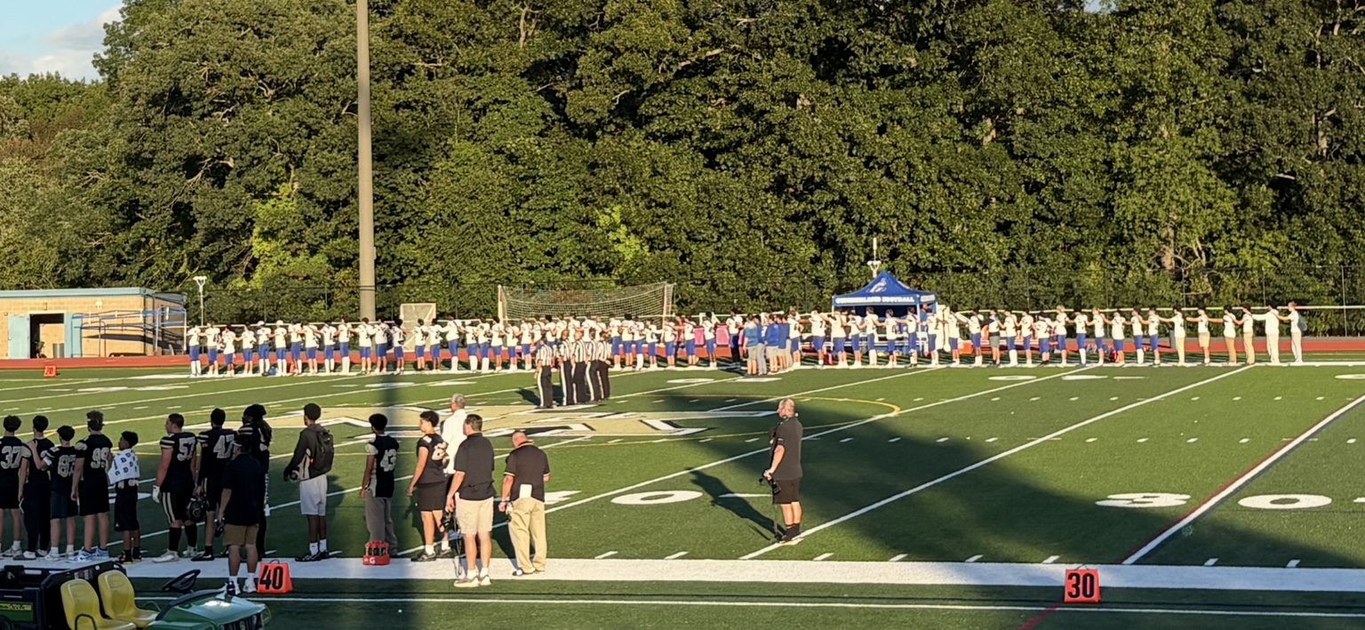 Cumberland and North Kingstown football teams lined up across the field before the game